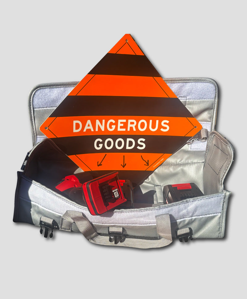 Open EXM Bag with 'Dangerous Goods' sign and power tool batteries on a light grey background
